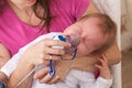 Inhalation child makes baby mama Royalty Free Stock Photo