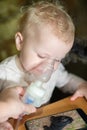 Inhalation makes child at home. Treatment of disspirators diseases with nebulizer with medication Royalty Free Stock Photo