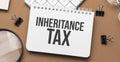inheritance tax on notepad with pen, glasses and calculator