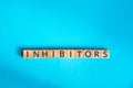 inhibitors inscription wooden cubes with letters Royalty Free Stock Photo