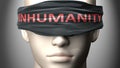 Inhumanity can make things harder to see or makes us blind to the reality - pictured as word Inhumanity on a blindfold to Royalty Free Stock Photo