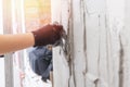 Initial application of putty and plaster on concrete wall to level surface Royalty Free Stock Photo