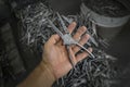 Initial blank of pliers before processing in hand. Tool producing by forging method at metallurgical plant