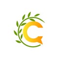 Initial letter C with paper and leaf shape in green and orange