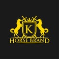 Initial Letter K Logo. Horse Brand Logo design vector. Retro golden crest with shield and horses. Heraldic logo template. Royalty Free Stock Photo