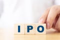 Initial public offering IPO concept. Alphabet letter on wooden cube block Royalty Free Stock Photo