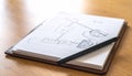 Handdrawn flowchart sketch in a notepad on a wooden desk Royalty Free Stock Photo