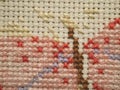 The initial stage of embroidery with floss threads on the canvas of a large picture with colorful butterflies. Hand made and hobby