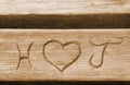 Initials of a love couple, carved in a bench plank