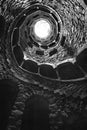 The Initiation well of Quinta da Regaleira in Sintra, Portugal in black and white , downside view.