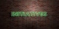 INITIATIVES - fluorescent Neon tube Sign on brickwork - Front view - 3D rendered royalty free stock picture Royalty Free Stock Photo