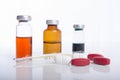 Injection ampule with pills show medicine concept Royalty Free Stock Photo