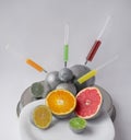 Injection into citrus fruits - orange, grapefruit, lemon, lime. Concept for genetically modified food. GMO. Royalty Free Stock Photo