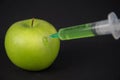 Injection green liquid into apple