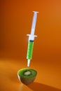 Injection with syringe to a green kiwi fruit