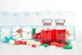 Injection vials and medicine in weekly pill box Royalty Free Stock Photo