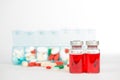 Injection vials and medicine in weekly pill box Royalty Free Stock Photo