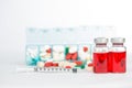 Injection vials and medicine in weekly pill box Royalty Free Stock Photo