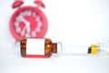 Injection vials and syringe on redclock background Royalty Free Stock Photo