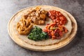 Injera is a sourdough flatbread made from teff flour served with filling close up on the wooden board. Horizontal Royalty Free Stock Photo