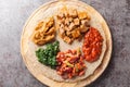 Injera is a sourdough flatbread made from teff flour served with filling close up on the wooden board. Horizontal top view Royalty Free Stock Photo
