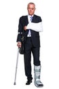 Injred businessman on crutches on white Royalty Free Stock Photo