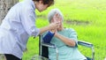 Injured asian senior woman wearing elbow support suffering from sore muscle,elbow joint arm pain,female caregiver do not intend to