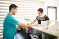 Injured Athlete Filling Medical Form While Physiotherapist Stand