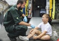 Injured boy getting help from paramedics Royalty Free Stock Photo