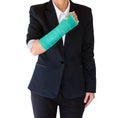 Injured businesswoman with broken hand and green cast standing