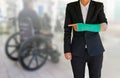 Injured businesswoman with green cast on hand and arm on blurred