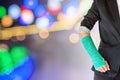 Injured businesswoman with green cast on hand and arm on light b