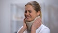 Injured female in foam cervical collar suddenly feeling sharp pain in neck