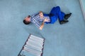 Injured Handyman Lying On Floor