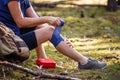 Injured hiker putting elastic bandage to her knee Royalty Free Stock Photo