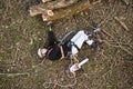 Injured lumberjack with chainsaw lying on the ground after fall