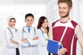 Injured male with broken arm standing in front of his doctor