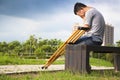 Injured Man with crutches sitting on a bench Royalty Free Stock Photo