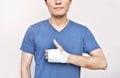 Injured man with hand in bandage showing thumb up sign symbol Royalty Free Stock Photo