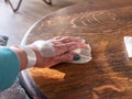 Injured painful hand with white bandage, take a plaster off the table Royalty Free Stock Photo