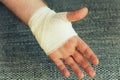Injured painful hand with white gauze bandage