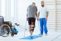 Patient learns to walk on crutches in medical office