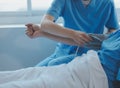 Injured patient showing doctor broken wrist and arm with bandage in hospital office or emergency room. Sprain, stress fracture or Royalty Free Stock Photo