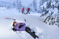 Injured skier after accident waiting for rescue