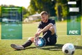 Injured soccer player with ball on football field Royalty Free Stock Photo