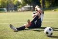 Injured soccer player with ball on football field Royalty Free Stock Photo