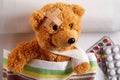 Injured teddy bear with arm in a sling