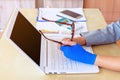 injured woman with blue elastic bandage on hand and holding eyeg