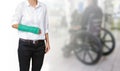 Injured woman with green cast on hand and arm on on blu Royalty Free Stock Photo