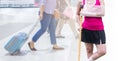 Injured woman with green cast on hand and arm on blurred background traveler with suitcase in airport, insurance travel